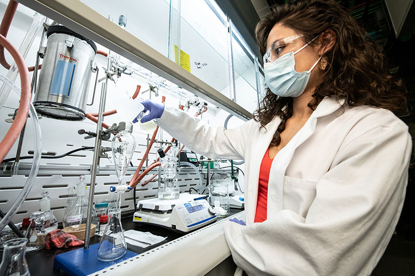 Photo of a researcher working with lab equipment