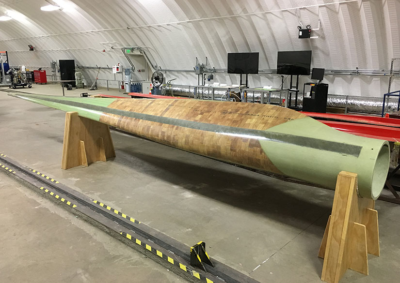 Photo of a wind turbine blade inside a research facility