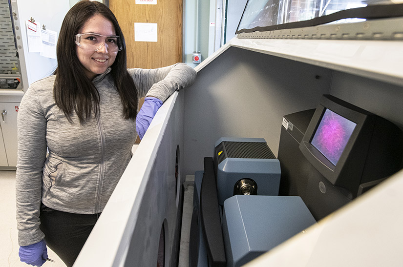 Photo of a woman standing in front of a DSC/TGA instrument. 