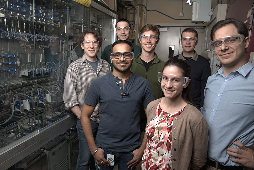 Photo of a group of researchers in a lab smiling at the camera