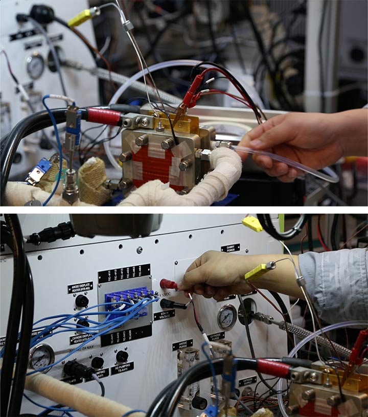 Researcher testing electrolyzer components.