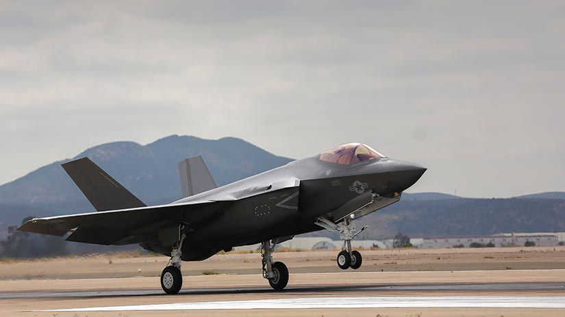 Photo of an F-35C jet taking landing on a runway.