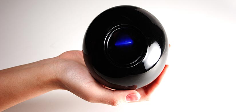 Photo of a hand holding a magic 8-ball.