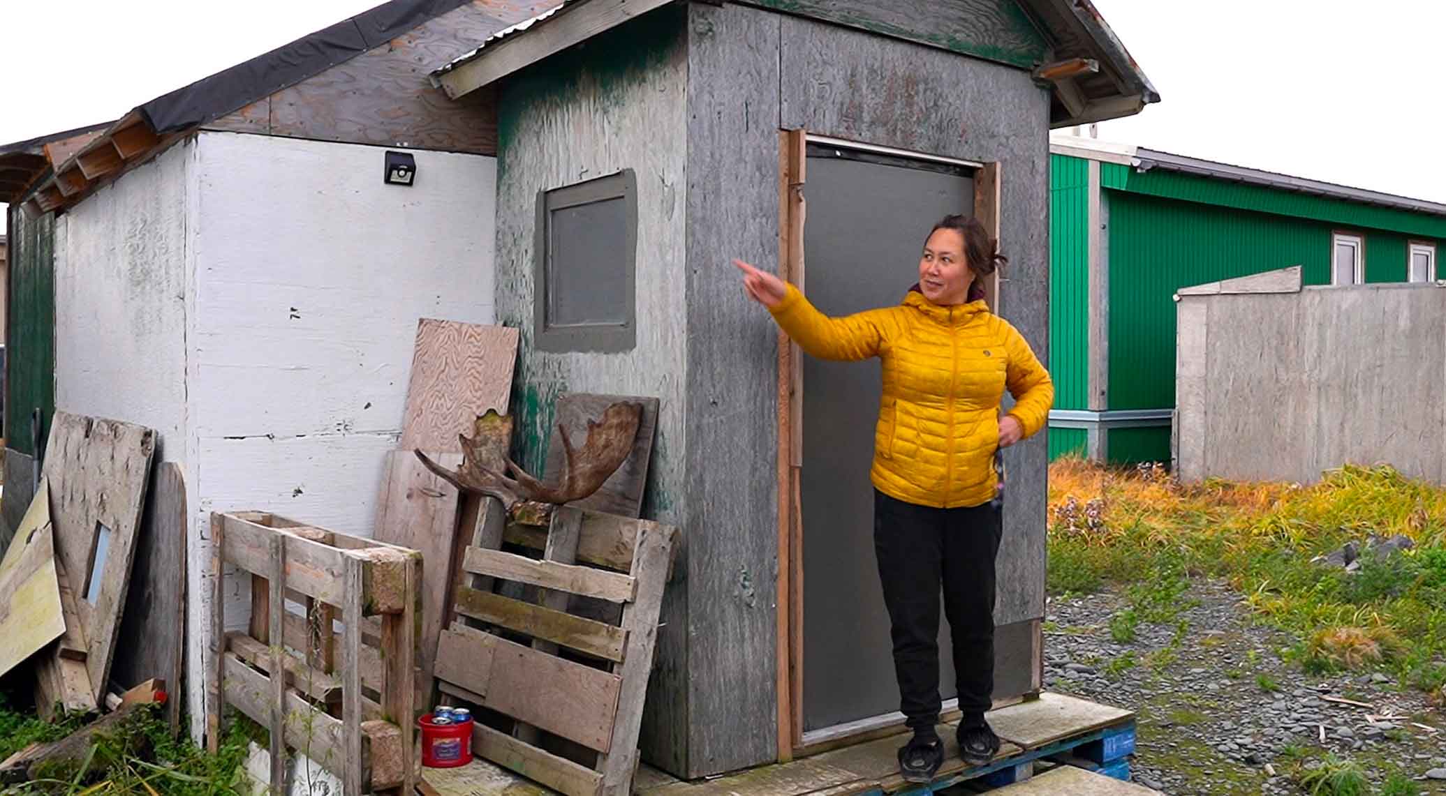 Christy standing in front of the sauna.