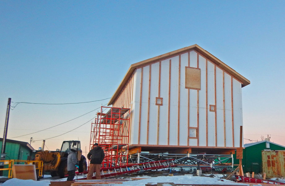 Photo of the home wrapped in insulation.