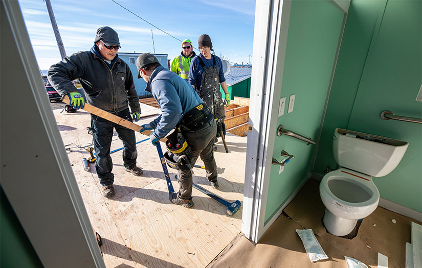 Contractors work on a new home in Unalakleet, Alaska