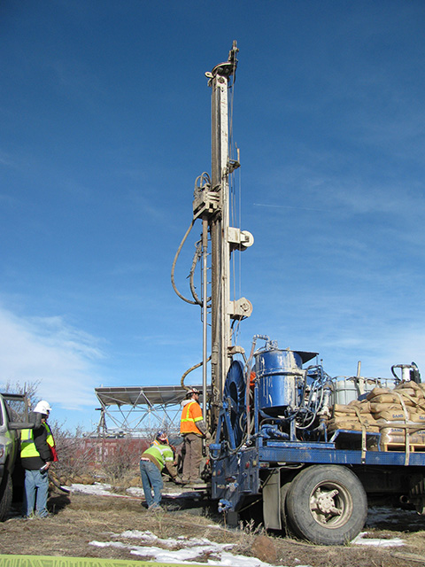 A drilling rig installing a geothermal heat pump.
