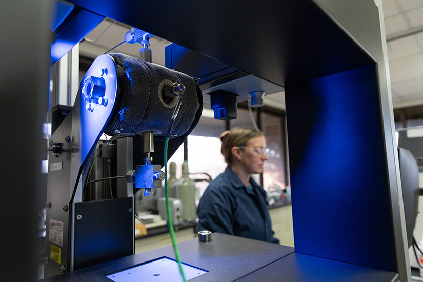 A woman operates laboratory equipment