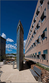 Photo of a large fin-shaped air intake on the outside of a three-story building.