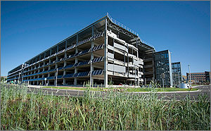 Wide photo of the parking garage showing photovoltaic panels on the south side.