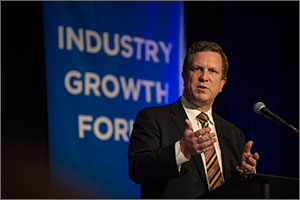 Photo of a man standing at a podium speaking.