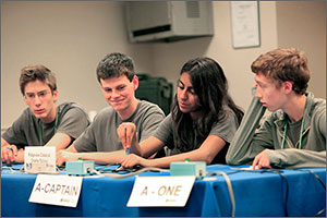 Photo shows four students sitting at a table during the National Science Bowl competition.