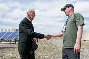 Photo of two men shaking hands.