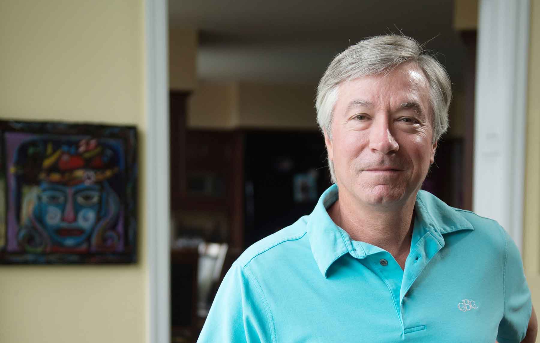 Photo shows the founder of e-Chromic standing in his home.