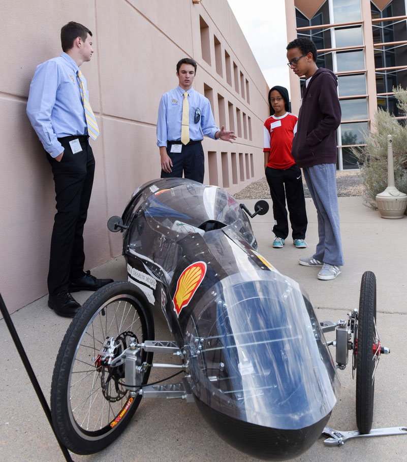 Students show visitors to NREL's Education Center their winning car.