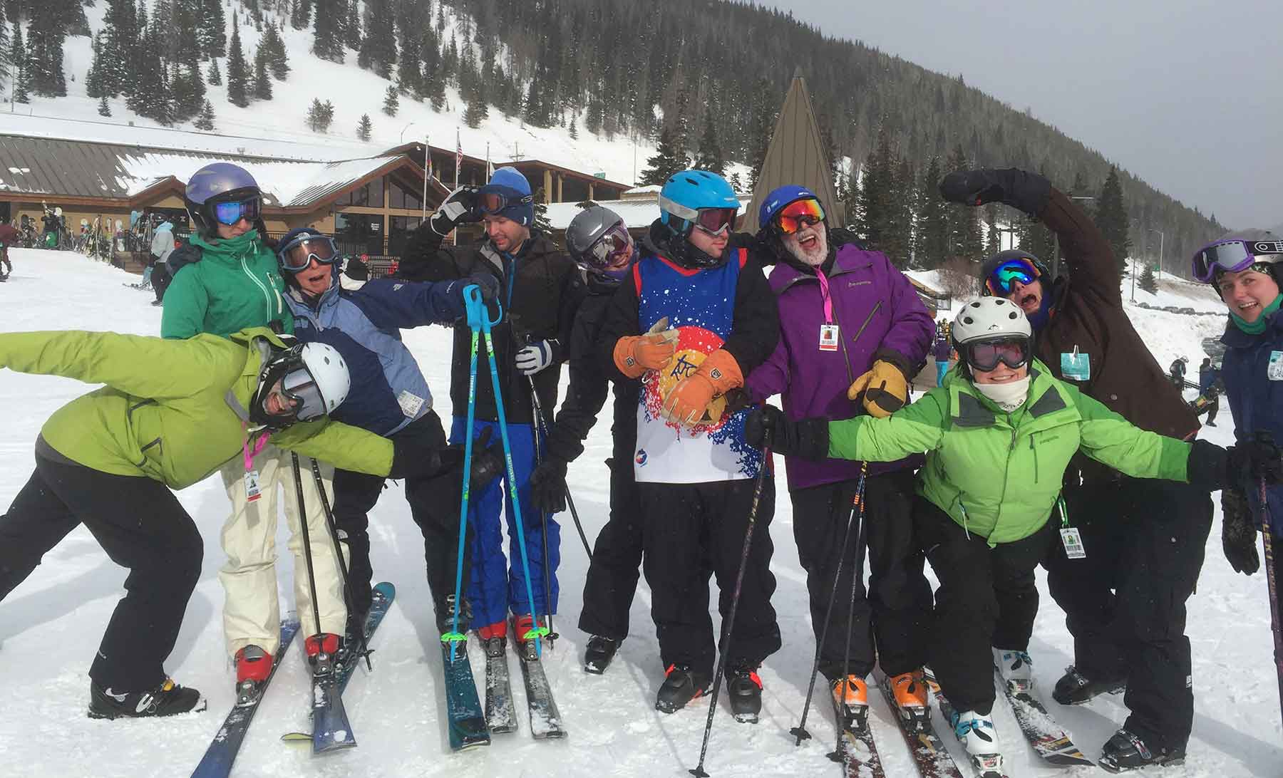 A group of skiers pose on a slope.