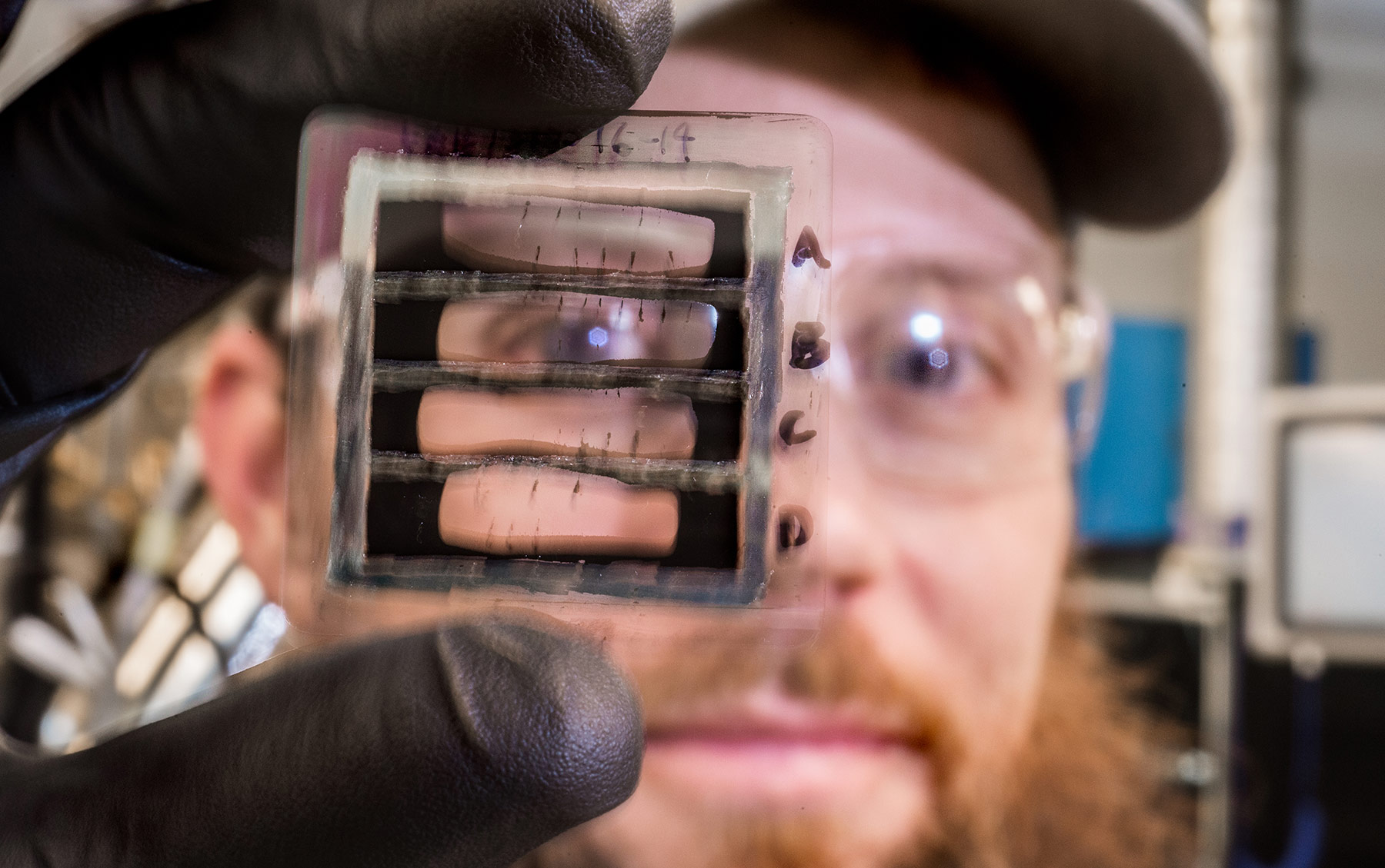 A man looks through a small clear object.