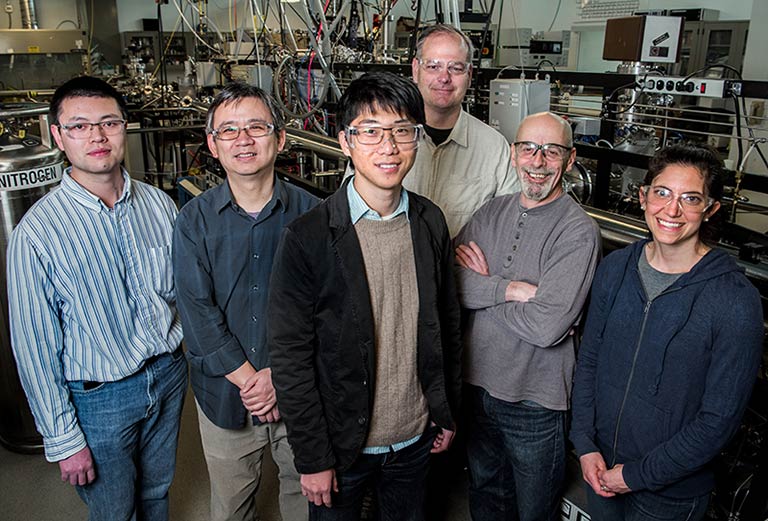 Six scientists involved with the newly published research into perovskites stand inside a laboratory.