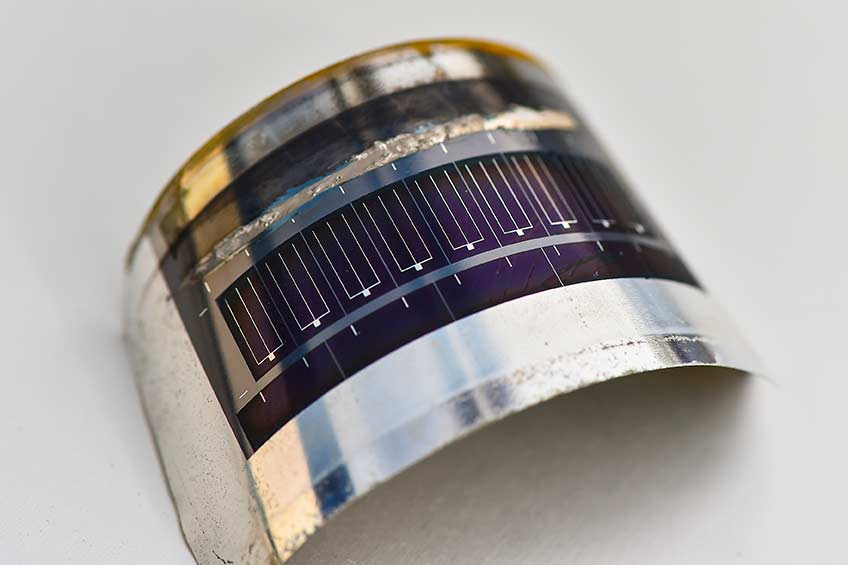 Photo shows a solar cell affixed to a curved piece of stainless steel.