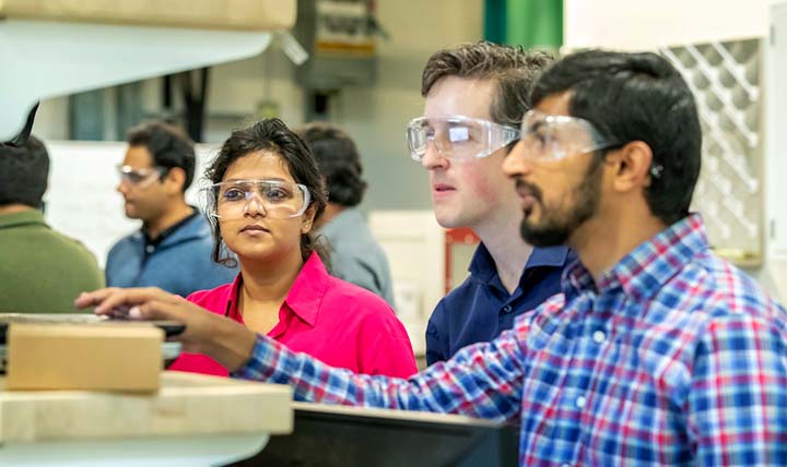 Several NREL researchers in the lab discuss the PRECISE tool.