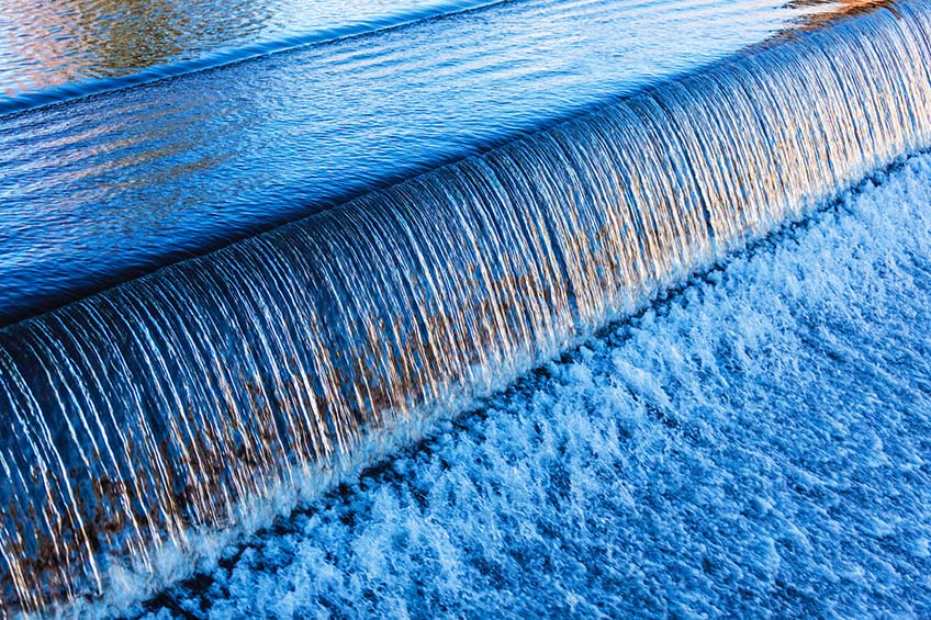 Water flowing over a dam