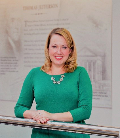 Photo of a woman standing in front of a Thomas Jefferson exhibit