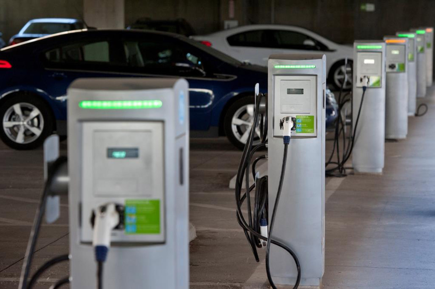 Photo of electric vehicle charging stations in parking garage.