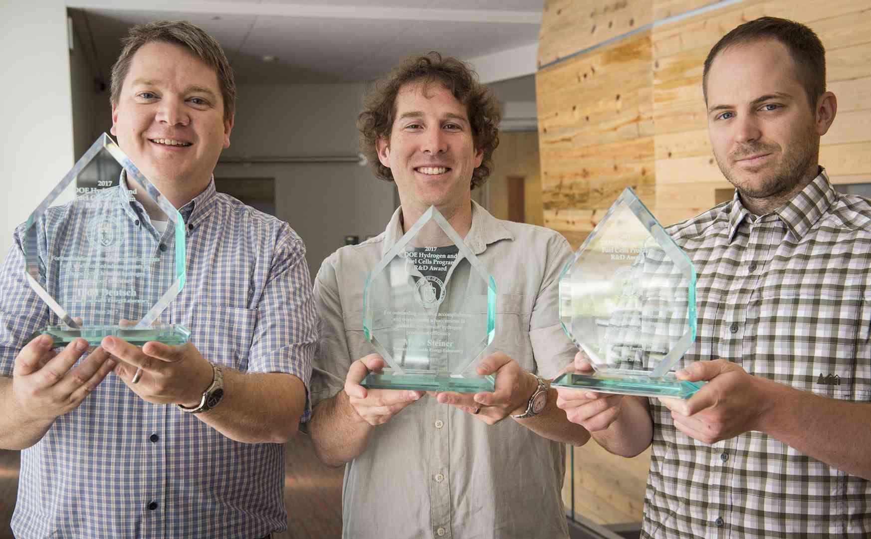 Todd Deutsch, Myles Steiner, and James Young pose with their Annual Merit Review awards