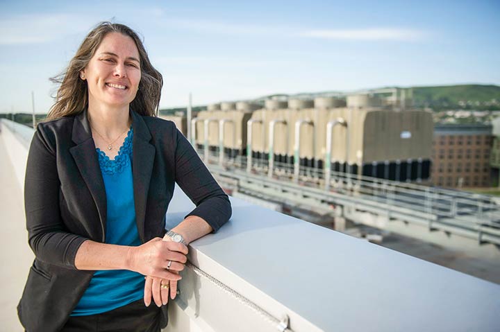 NREL Sheila Hayter standing on facility rooftop outside.