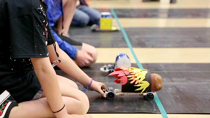 Close-up of students kneeling by race starting line