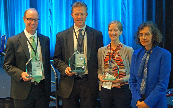 Three NREL researchers accept an award from DOE