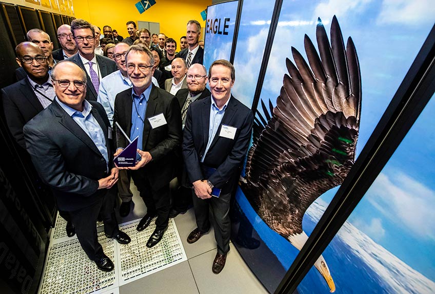 Photo of a supercomputer with an image on one side of an eagle flying past snow-covered mountains. 