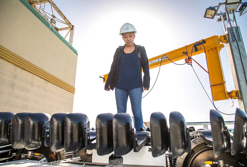 A hydropower worker examines equipment.