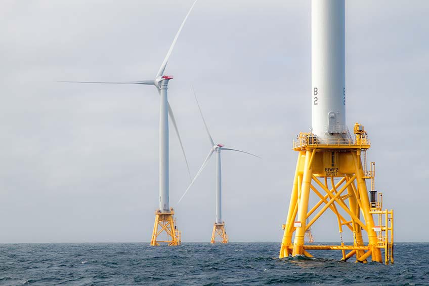 Three offshore wind turbines off the coast of Rhode Island.