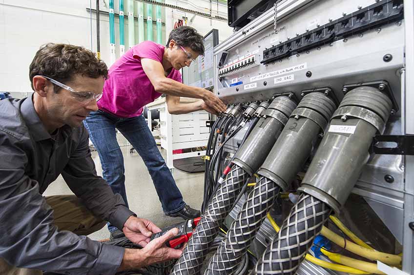 NREL researchers work on the Consolidated Utility Base Energy System.