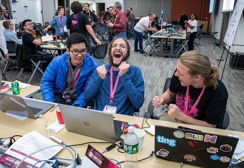 Students sit in front of their laptops.