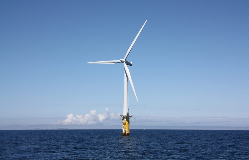 A photo of an offshore wind turbine floating in the ocean.