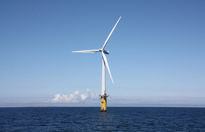 Photo of offshore wind turbines floating in the ocean.