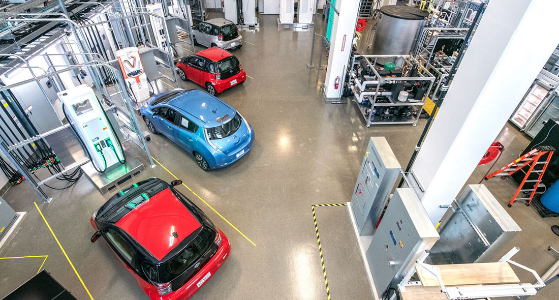 Four electric vehicles are parked at charging stations within the Energy Systems Integration Facility. 