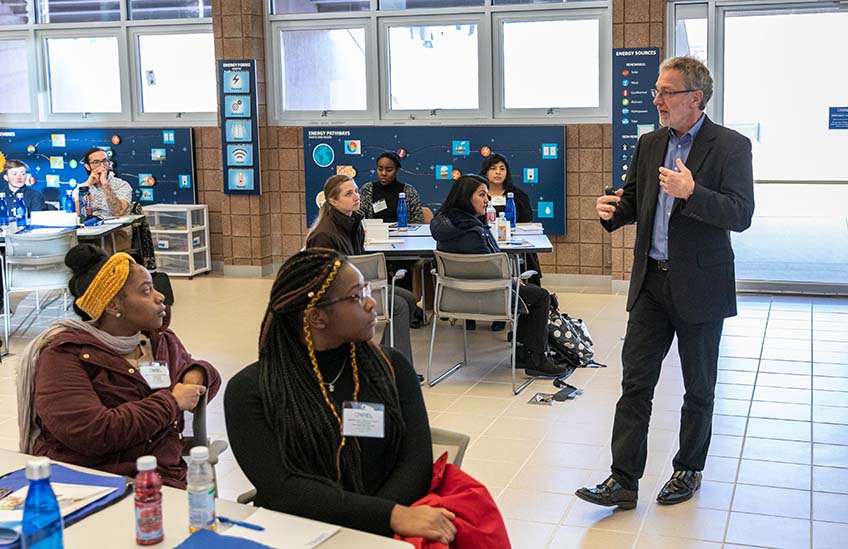 A man talks to a roomful of college students.