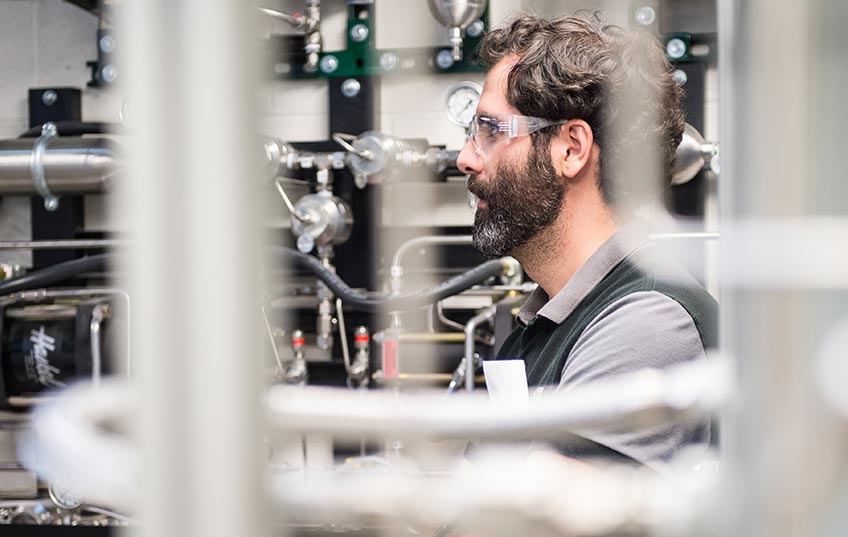 A scientist looks at equipment in a laboratory.