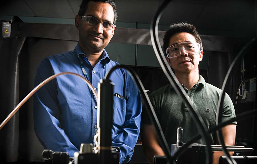 Sreekant Narumanchi and a colleague with an experimental setup of thermoreflectance technique, in the Laser Lab in Building 16