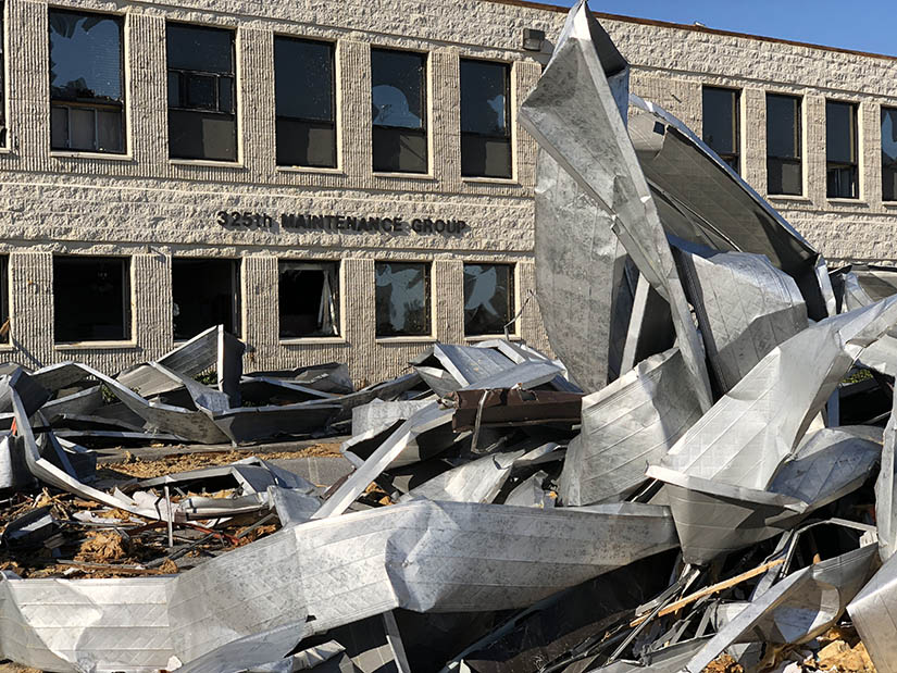 A large government building surrounded by building debris from a hurricane