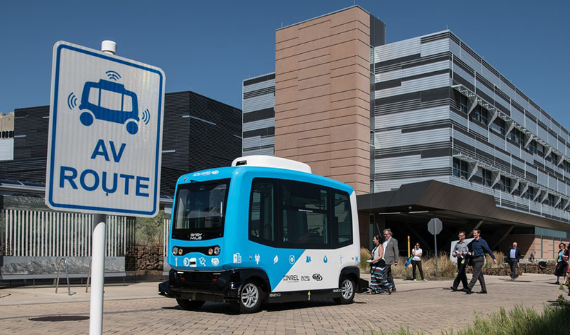 An automated electric vehicle makes a lap around the NREL campus.