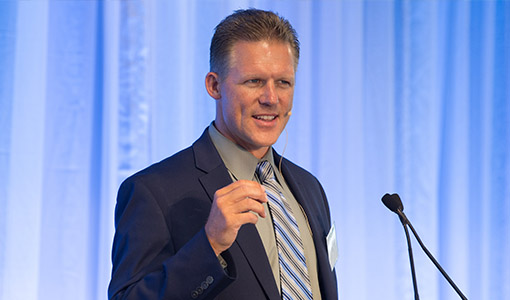 Photo of a man speaking on stage