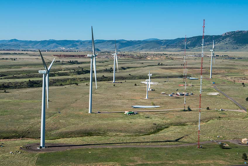 An aerial photograph of a energy laboratory campus with wind turbines.