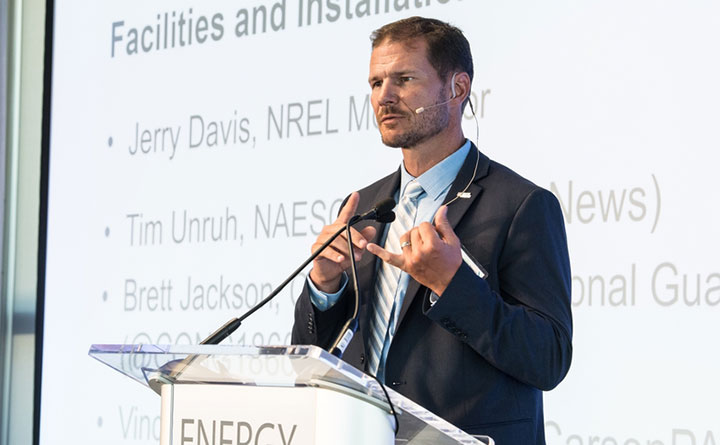 Photo of a man speaking at a podium.