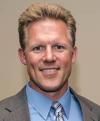 A headshot of a person smiling.