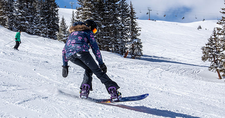 Charisa Powell in full snow gear snowboarding