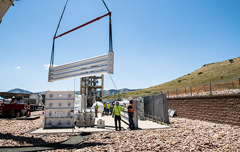 Construction equipment outside of the Energy Systems Integration Facility working on the new expansion of the Hydrogen Storage Pad at NREL.